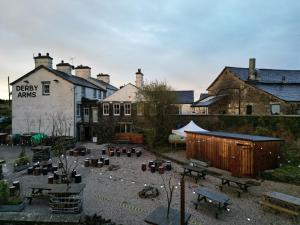 a group of buildings with a courtyard with benches at The Derby Arms in Grange Over Sands