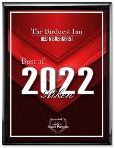 a red and white sign with the words the brightest im bed and breakfast at The Birdnest Inn in Aiken