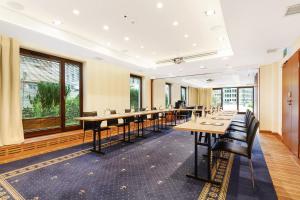 a large conference room with long tables and chairs at Hotel Gdańsk Boutique in Gdańsk