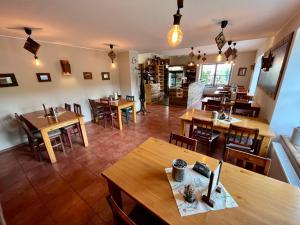 イェセニークにあるHotel STARÝ MLÝNの木製のテーブルと椅子が備わる空きレストランです。
