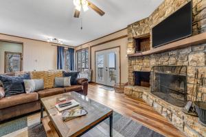 a living room with a couch and a fireplace at Skyleaf 703 in Sugar Mountain