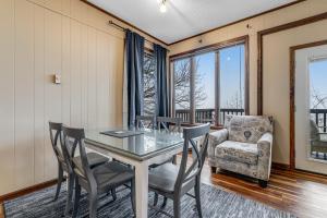 a dining room with a glass table and chairs at Skyleaf 703 in Sugar Mountain