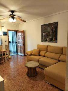 a living room with a couch and a table at Aitana Apartment in Gran Alacant