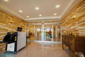 a lobby with a cash register and a brick wall at Royal Sahel in Birmandreis