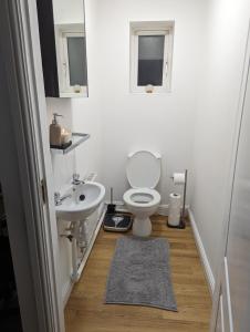 a bathroom with a toilet and a sink at Greatmindz's home away from home in Bloxwich
