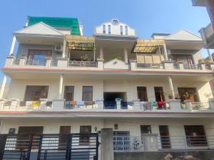 a large white building with a lot of balconies at Negi Lodge Chandigarh in Chandīgarh