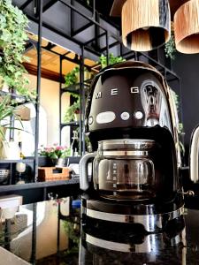 a black coffee maker sitting on a counter at Monsenhor52 in Porto