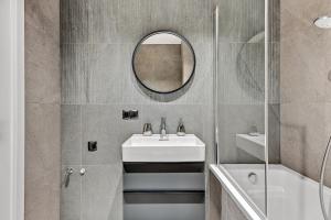 a bathroom with a sink and a mirror at Dom & House - Apartments Old Town Scala in Gdańsk