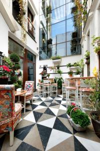 a patio with chairs and tables in a building at Casa Palacete 1822 in Granada