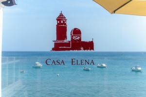 a lighthouse in the middle of the water with boats at Casa Lola y Elena - Playa Blanca, Lanzarote in Playa Blanca