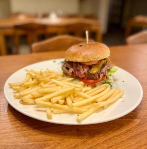 a white plate with a sandwich and french fries at Hotel STARÝ MLÝN in Jeseník