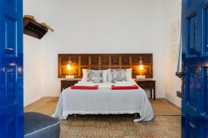 a bedroom with a large bed with blue doors at Casa Rural Caleton del Golfo in El Golfo