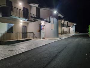 an empty street in front of a building at night at Gerberarooms in Pozzilli