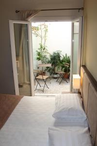 a bedroom with a bed and a view of a patio at Rea Hotel in Heraklio