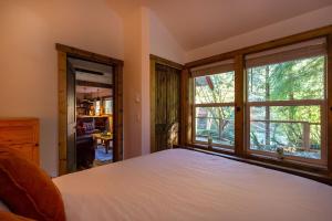 1 dormitorio con cama y ventana grande en Rusty Bridge River Lodge, en Granite Falls