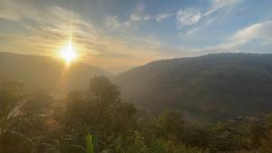 a view of the sun rising over a mountain at Kalasita in Mahabaleshwar