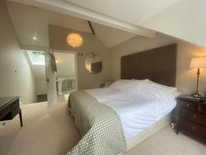 a bedroom with a large white bed and a desk at Beautiful 1 bedroom holiday home in Lancaster in Lancaster