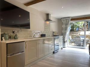 a kitchen with a sink and a stove top oven at Beautiful 1 bedroom holiday home in Lancaster in Lancaster