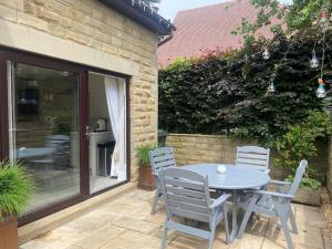 a table and chairs sitting on a patio at Beautiful 1 bedroom holiday home in Lancaster in Lancaster