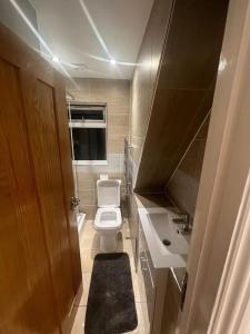 a small bathroom with a toilet and a sink at Hampden Rd N8,Studio Flat in London