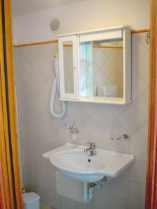 a bathroom with a sink and a medicine cabinet at Ludovica Apartment in Positano