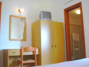 a bedroom with a desk and a dresser with a mirror at Ludovica Room in Positano