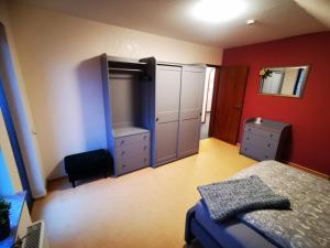 Schlafzimmer mit einem Bett, einer Kommode und einem Spiegel in der Unterkunft Haus Kalli in Walkenried
