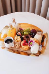 a tray of breakfast foods and coffee on a table at ORM- Flores Apartment in Porto