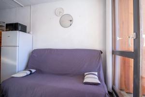 a small room with a bed and a refrigerator at Comfortable apartment with beautiful view - Welkeys in LʼHuez