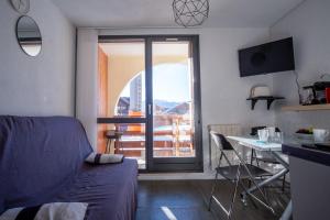a bedroom with a bed and a desk and a window at Comfortable apartment with beautiful view - Welkeys in LʼHuez