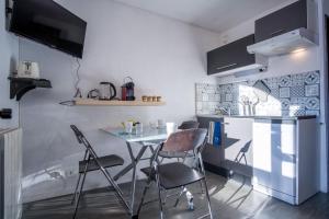 a kitchen with a table and chairs in a room at Comfortable apartment with beautiful view - Welkeys in LʼHuez