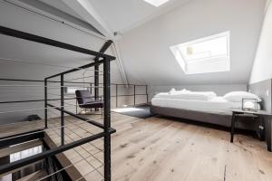 a bedroom with a bed and a desk and a chair at Stay COOPER l CITY LOFT in Bolzano