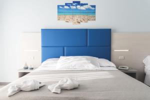 a bedroom with a bed with two towels on it at Hotel Continental in Tortoreto Lido
