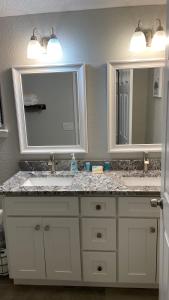 a bathroom with two sinks and two mirrors at The Jewel of Jacksonville in Jacksonville +21 photos