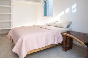 a bedroom with a bed and a wooden table at Casa Medina in Chetumal +34 photos