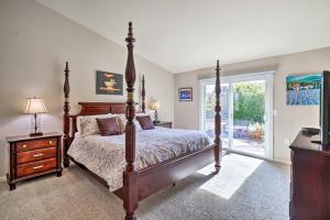 a bedroom with a large bed and a window at Reno Home with Private Yard and Hot Tub in Reno