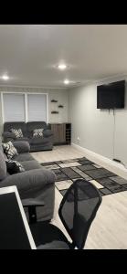 a living room with a couch and a flat screen tv at The Jewel of Jacksonville in Jacksonville