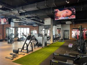 a gym with a flat screen tv and tread machines at The Best Apartment on the beach 'Caesar Beach' Bogaz, North Cyprus in Boghaz