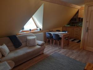 a living room with a couch and a table at Apartament w Równi in Chochołów
