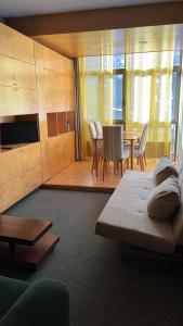 a living room with a couch and a table and chairs at Tobazo Candanchú pie de pista in Candanchú