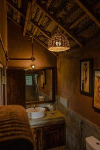 a bathroom with a sink and a mirror at Gaga Bees Yala in Tissamaharama