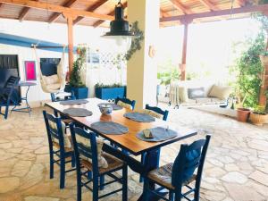 a dining room with a wooden table and chairs at Chrysa's Holiday Apartment in Pylos