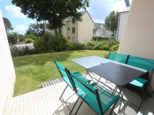 a table and chairs sitting on a patio at Bénodet : Superbe T2 rénové à 100m de la plage, parking inclus - FR-1-481-90 in Bénodet