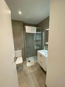 a bathroom with a shower and a toilet and a sink at CP High floor luxury studio in Gibraltar