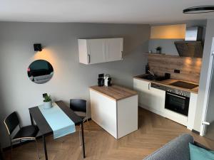 a kitchen with a table and a counter top at Ebbe&Flut in Bremerhaven