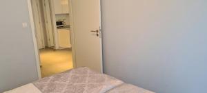 a door leading to a room with a bedroom at Apartamenty Czarna Góra L16 in Sienna