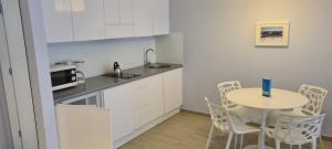 a small kitchen with a table and a microwave at Apartamenty Czarna Góra L16 in Sienna