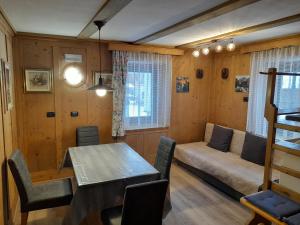 a living room with a table and a couch at Ciasa Rosada in San Vigilio Di Marebbe