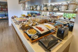 a buffet line with many different types of food at Nova Pousada dos Chás in Florianópolis