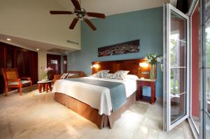 a bedroom with a large bed with a ceiling fan at Grand Palladium Bavaro Suites Resort & Spa - All Inclusive in Punta Cana